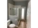 Bathroom featuring a tiled shower with glass doors and neutral colored walls and tile flooring at 7924 Bridgestone Dr, Orlando, FL 32835