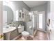 Bathroom features a vessel sink, medicine cabinet, glass shower and tile floors at 7924 Bridgestone Dr, Orlando, FL 32835