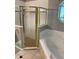 Bathroom featuring a garden tub and glass enclosed shower with gold trim at 7924 Bridgestone Dr, Orlando, FL 32835