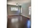 Bedroom features wood flooring, multiple windows, and a ceiling fan at 7924 Bridgestone Dr, Orlando, FL 32835