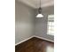 An empty dining room featuring a decorative light fixture and natural light from the window at 7924 Bridgestone Dr, Orlando, FL 32835