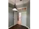 Open doorway with decorative hanging light fixture, hardwood floors and transom window at 7924 Bridgestone Dr, Orlando, FL 32835