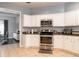 Bright kitchen features white cabinetry, stainless steel appliances, and granite countertops at 7924 Bridgestone Dr, Orlando, FL 32835