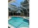 Sparkling pool and spa featuring an inviting screened enclosure for year-round enjoyment at 7924 Bridgestone Dr, Orlando, FL 32835