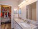 Well-lit bathroom features double sinks, granite countertops, and closet access at 835 Grand Regency Pt # 104, Altamonte Springs, FL 32714