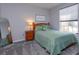 Cozy bedroom features a comfortable bed, side table, and a window letting in natural light at 835 Grand Regency Pt # 104, Altamonte Springs, FL 32714