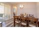 Bright dining area featuring a wooden table, crossback chairs, and sliding doors leading to an outdoor space at 835 Grand Regency Pt # 104, Altamonte Springs, FL 32714