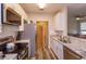 Modern kitchen boasting white cabinets, stainless steel appliances, and a view into the cozy living room at 835 Grand Regency Pt # 104, Altamonte Springs, FL 32714