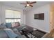Modern living room showcasing a comfortable gray sectional, a contemporary rug, and a mounted flat-screen television at 835 Grand Regency Pt # 104, Altamonte Springs, FL 32714