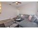 Inviting living room with a comfortable gray sectional sofa, stylish rug, and a ceiling fan for added comfort at 835 Grand Regency Pt # 104, Altamonte Springs, FL 32714