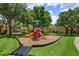 Community playground featuring colorful play structures and ample green space, ideal for Gathering fun at 835 Grand Regency Pt # 104, Altamonte Springs, FL 32714