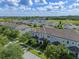 Stunning aerial view of townhomes featuring lush landscaping and expansive green spaces in the neighborhood at 9591 Amber Chestnut Way, Winter Garden, FL 34787