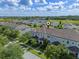 Desirable townhome community from above featuring manicured lawns, serene streets, and green landscape at 9591 Amber Chestnut Way, Winter Garden, FL 34787