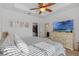 Brightly lit bedroom featuring a ceiling fan, tv, closet, and dresser at 9591 Amber Chestnut Way, Winter Garden, FL 34787