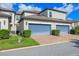 Charming two-story townhome with blue garage door, brick driveway, and well-maintained landscaping at 9591 Amber Chestnut Way, Winter Garden, FL 34787