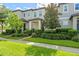 Charming townhouse with well-manicured landscaping and a sidewalk leading to the entrance at 9591 Amber Chestnut Way, Winter Garden, FL 34787