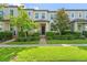 Well-maintained townhouse featuring a landscaped front yard and a welcoming entrance at 9591 Amber Chestnut Way, Winter Garden, FL 34787