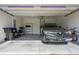 Clean and organized two-car garage showcasing ample space for parking and storage with epoxy flooring at 9591 Amber Chestnut Way, Winter Garden, FL 34787