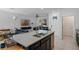 Spacious kitchen island with granite countertops, stainless steel appliances, and open view to the living room at 9591 Amber Chestnut Way, Winter Garden, FL 34787