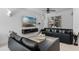 Comfortable living room with a ceiling fan, modern furnishings, and a large television at 9591 Amber Chestnut Way, Winter Garden, FL 34787