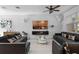 Spacious living room with modern decor, large windows, and comfortable leather sofas at 9591 Amber Chestnut Way, Winter Garden, FL 34787