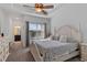 Well lit main bedroom featuring a ceiling fan and a window with natural light at 9591 Amber Chestnut Way, Winter Garden, FL 34787