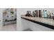 Pantry with wire shelving and granite countertop, ideal for storage and serving, next to various liquors at 9591 Amber Chestnut Way, Winter Garden, FL 34787