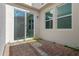 Private outdoor patio area, featuring brick pavers, offering a peaceful space for relaxation and leisure at 9591 Amber Chestnut Way, Winter Garden, FL 34787