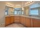 Bathroom featuring dual sinks, vanity, and ample lighting at 14014 Spruce Creek Ln, Orlando, FL 32828