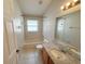 Well-lit bathroom with a bathtub, shower, toilet, and granite vanity at 14014 Spruce Creek Ln, Orlando, FL 32828