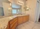 Bright bathroom featuring granite countertops, double sinks, and modern lighting fixtures at 14014 Spruce Creek Ln, Orlando, FL 32828