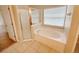 Bright bathroom showcases a luxurious tub and glass-enclosed shower at 14014 Spruce Creek Ln, Orlando, FL 32828