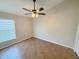 Bedroom featuring a ceiling fan, tiled floor, and window at 14014 Spruce Creek Ln, Orlando, FL 32828