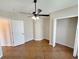 Bedroom boasting tiled floor, ceiling fan, and closet space at 14014 Spruce Creek Ln, Orlando, FL 32828