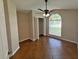 Bedroom with arched window, ceiling fan, and tiled floor at 14014 Spruce Creek Ln, Orlando, FL 32828