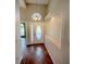 Elegant foyer with decorative tile flooring, recessed lighting, and a stylish front door with glass panel at 14014 Spruce Creek Ln, Orlando, FL 32828