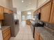 Well-equipped kitchen with stainless steel appliances, granite countertops, and ample cabinet space at 14014 Spruce Creek Ln, Orlando, FL 32828