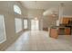 Open living room with tile floors, natural light, and sliding glass doors to screened patio at 14014 Spruce Creek Ln, Orlando, FL 32828