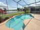 Inviting screened pool with clear blue water, surrounded by a patio and scenic lake views at 14014 Spruce Creek Ln, Orlando, FL 32828