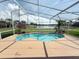 Screened pool offers a tranquil outdoor space with lake view and lush landscaping at 14014 Spruce Creek Ln, Orlando, FL 32828