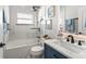 Modern bathroom with white marble-style tiles, updated fixtures, vanity, and stylish decor at 10064 River Glen Ct, Orlando, FL 32825