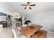 Bright dining area features wood table, chairs, and an open view to the kitchen and living area at 10064 River Glen Ct, Orlando, FL 32825