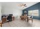 Combined dining and work space with a large table and an executive desk at 10064 River Glen Ct, Orlando, FL 32825