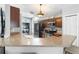 Kitchen bar featuring stone countertops and modern appliances in a well lit space at 10064 River Glen Ct, Orlando, FL 32825