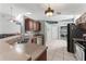 Open kitchen with modern appliances, ample counter space, and views to laundry area at 10064 River Glen Ct, Orlando, FL 32825