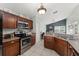 Charming kitchen with classic wood cabinets, modern appliances, and an open layout at 10064 River Glen Ct, Orlando, FL 32825