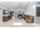 Bright living room featuring high ceilings, tile floors, and a comfortable sectional sofa at 10064 River Glen Ct, Orlando, FL 32825