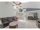 Spacious living room boasts vaulted ceilings, tiled floors, and open access to foyer and dining at 10064 River Glen Ct, Orlando, FL 32825
