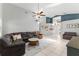Spacious living room features skylight, tile flooring, and open floor plan at 10064 River Glen Ct, Orlando, FL 32825