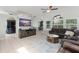 Open living area with tile flooring, large windows, and a cozy sectional sofa at 10064 River Glen Ct, Orlando, FL 32825